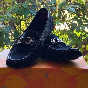 Donald Pliner black calf hair loafers with silver buckle accents.